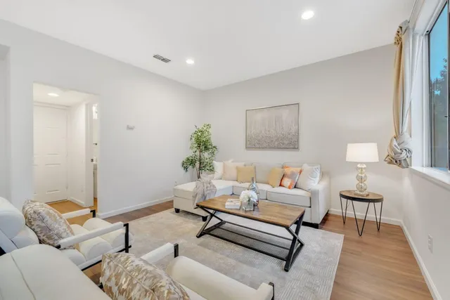 a living room with furniture and wooden floor