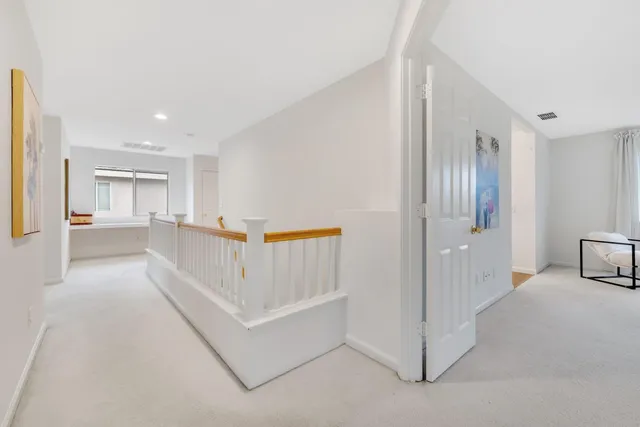 a view of a hallway with closet and a couch