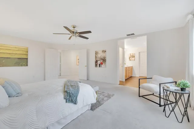 a spacious bedroom with a bed furniture and a window