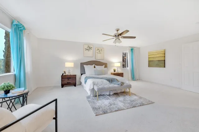 a bedroom with a large bed and a chandelier