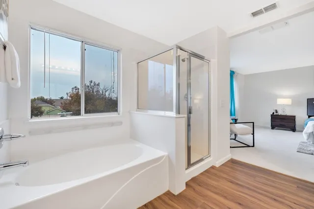 a bathroom with a bathtub and a shower