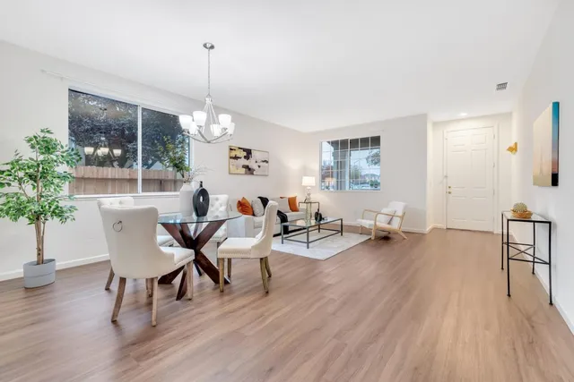 a living room with furniture a window and a potted plant