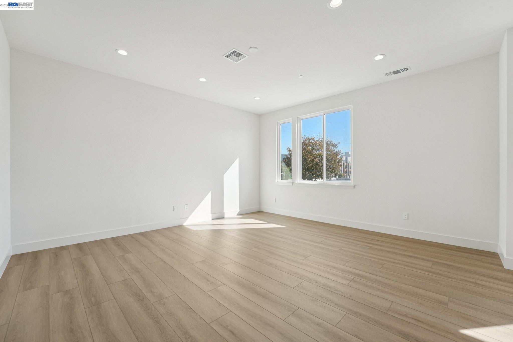 1933 Grand Street Alameda, CA 94501 - Photo 11 of 50 a view of an empty room with wooden floor and a window