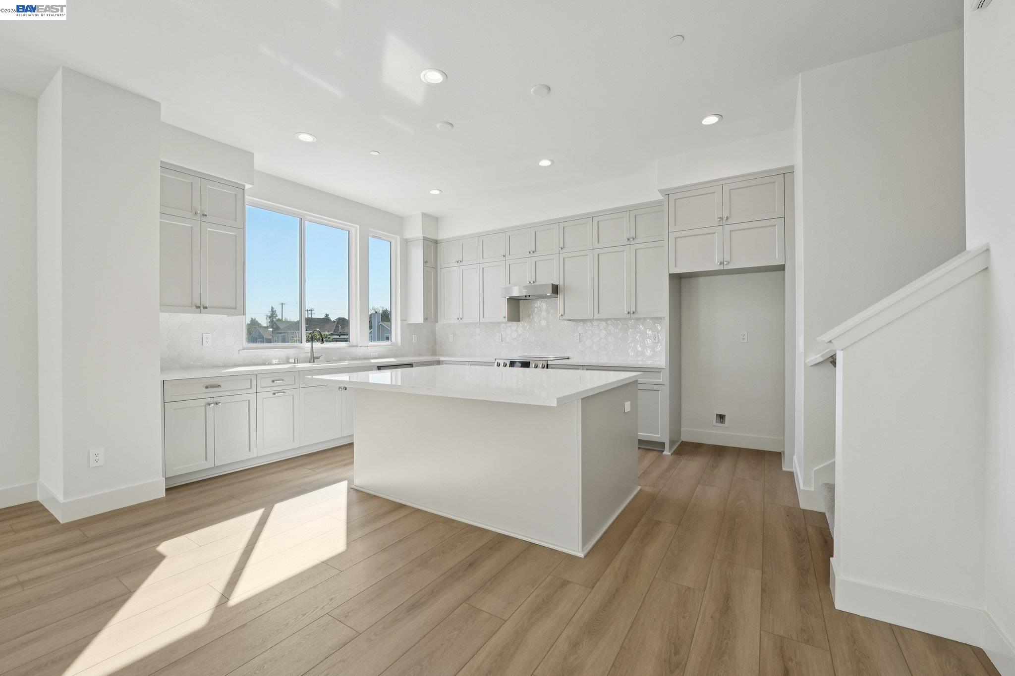 1933 Grand Street Alameda, CA 94501 - Photo 16 of 50 a kitchen with white cabinets sink and white stainless steel appliances