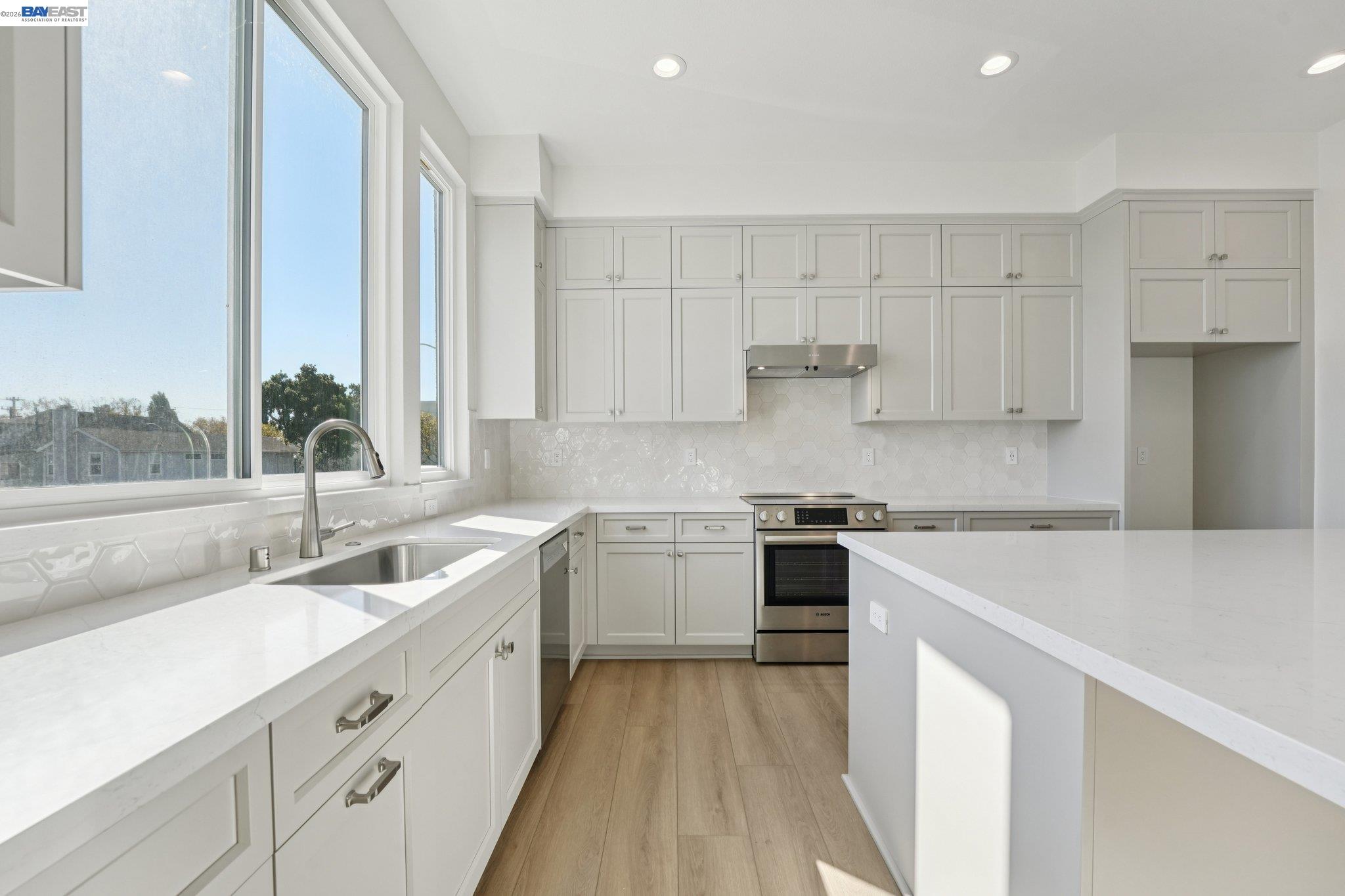 1933 Grand Street Alameda, CA 94501 - Photo 19 of 50 a kitchen with a sink stove and cabinets