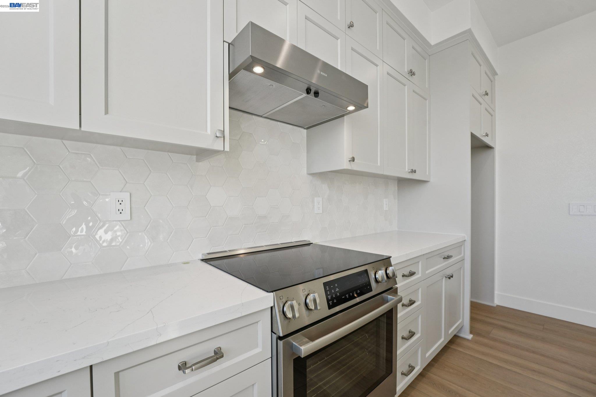 1933 Grand Street Alameda, CA 94501 - Photo 23 of 50 a kitchen with white cabinets and white appliances