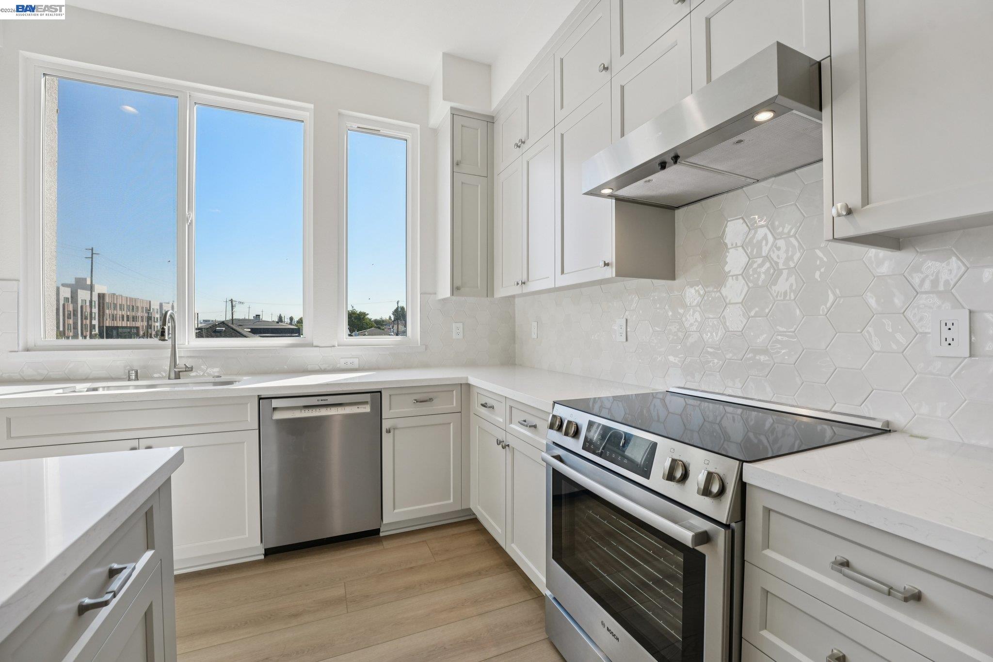 1933 Grand Street Alameda, CA 94501 - Photo 25 of 50 a kitchen with stainless steel appliances granite countertop a stove and a sink