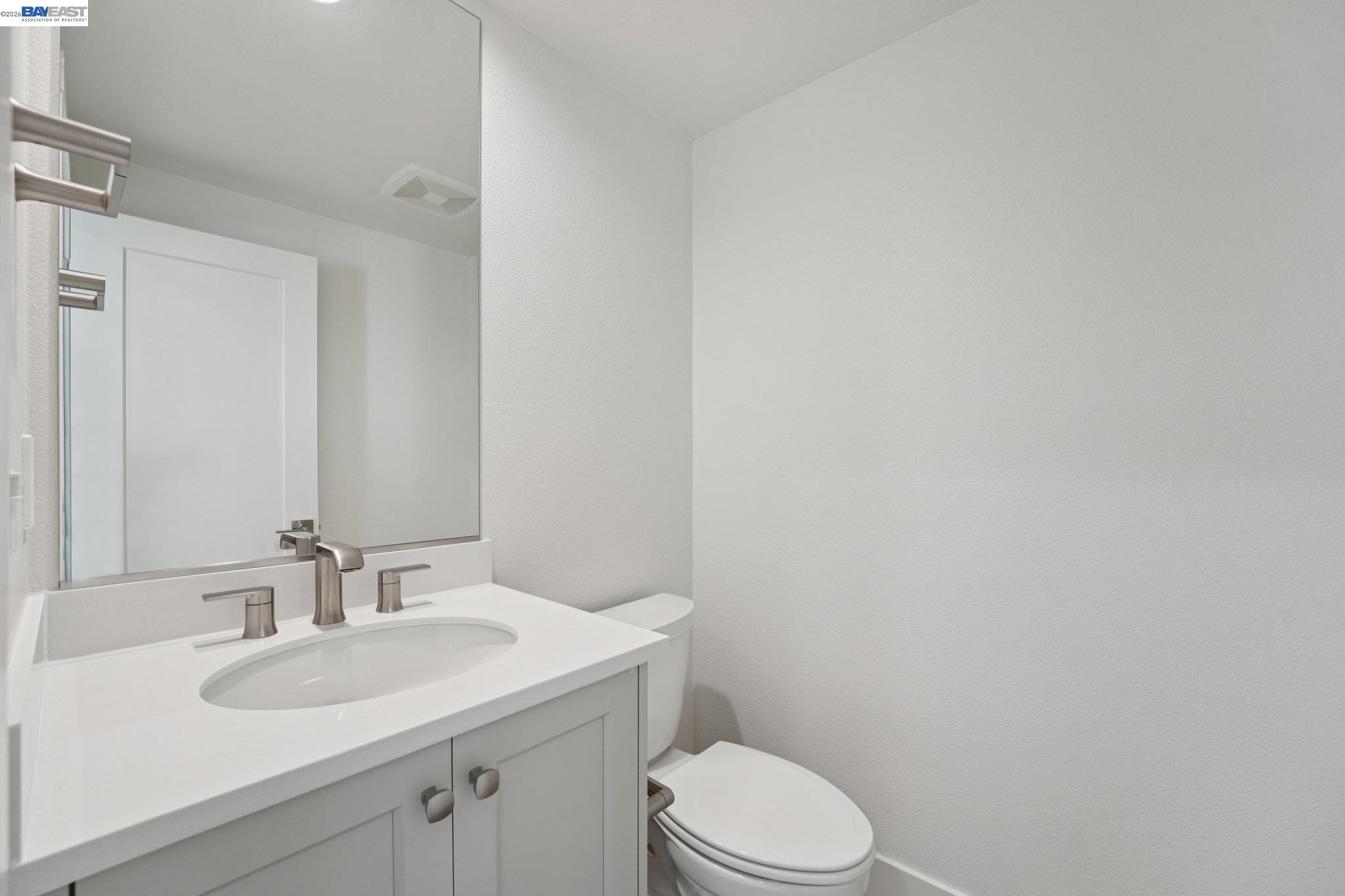 1933 Grand Street Alameda, CA 94501 - Photo 33 of 50 a bathroom with a sink a toilet and mirror