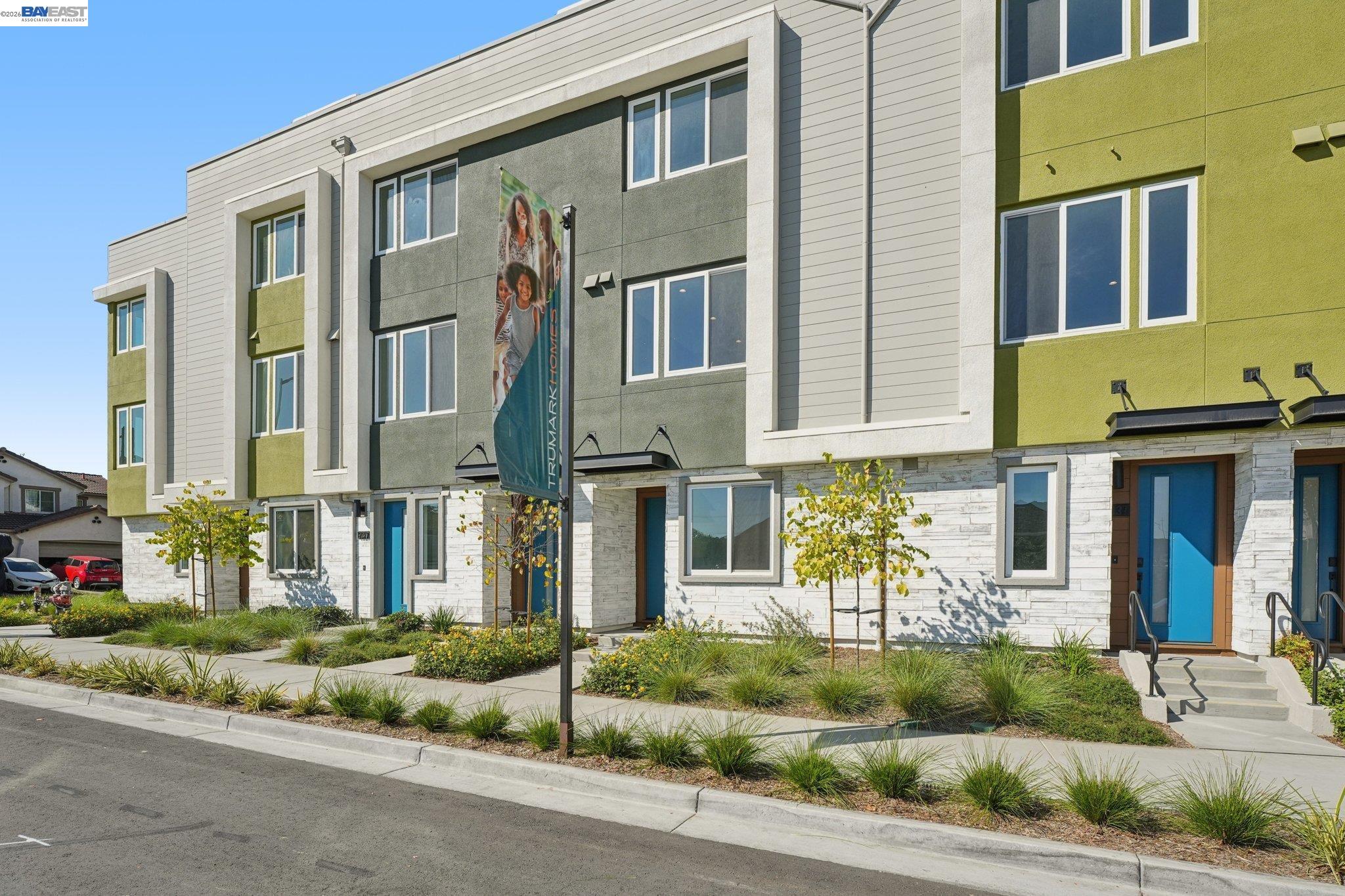 1933 Grand Street Alameda, CA 94501 - Photo 7 of 50 a front view of a residential apartment building with a yard
