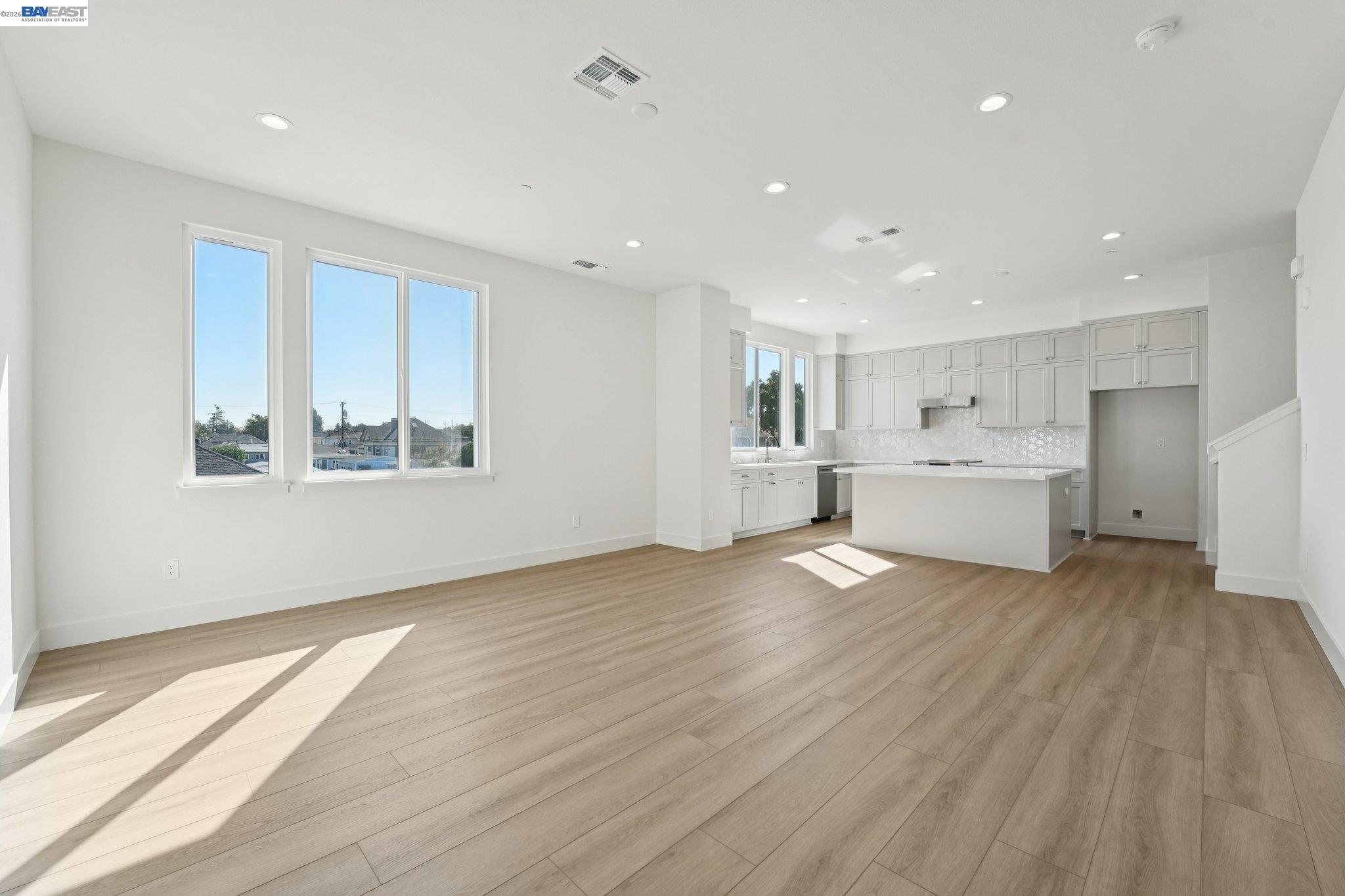 1933 Grand Street Alameda, CA 94501 - Photo 9 of 50 a view of an empty room with a window and wooden floor