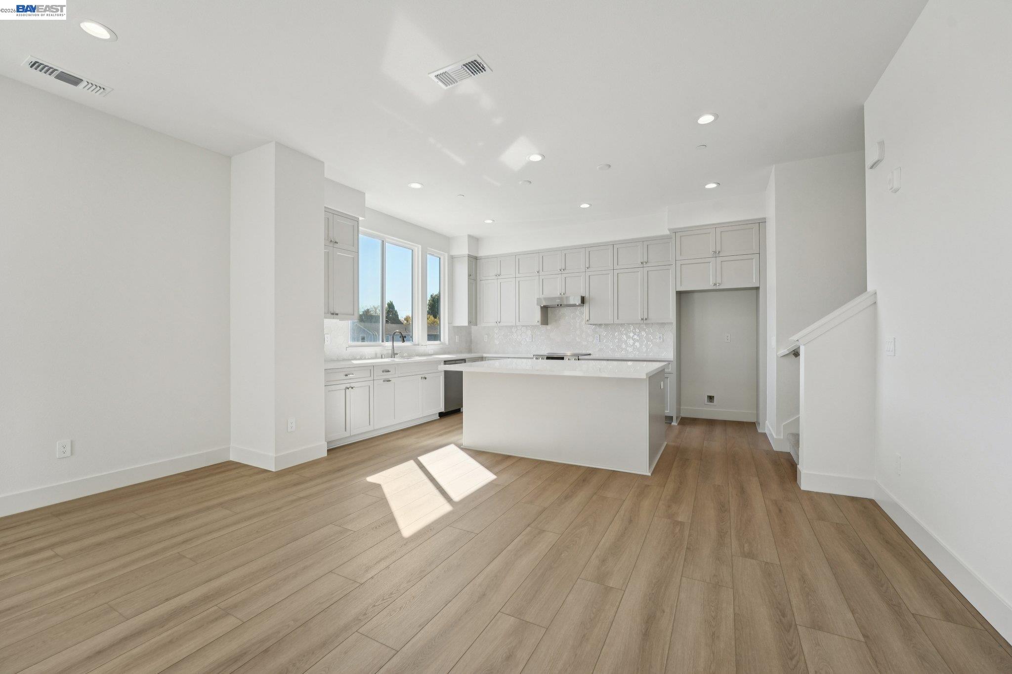 1933 Grand Street Alameda, CA 94501 - Photo 10 of 50 a view of a kitchen with wooden floor and windows