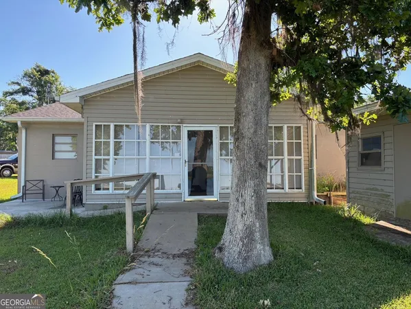 a front view of a house with garden