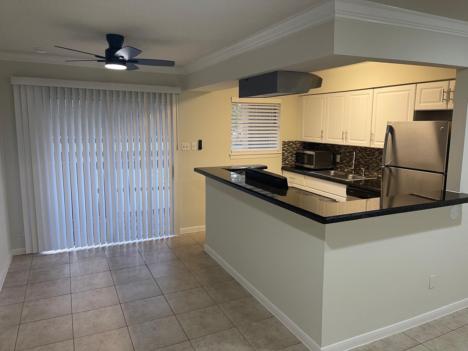 8229 Kingsbrook Road, Unit 228 Houston, TX 77024 - Photo 2 of 17 a kitchen with stainless steel appliances granite countertop a sink and a cabinets