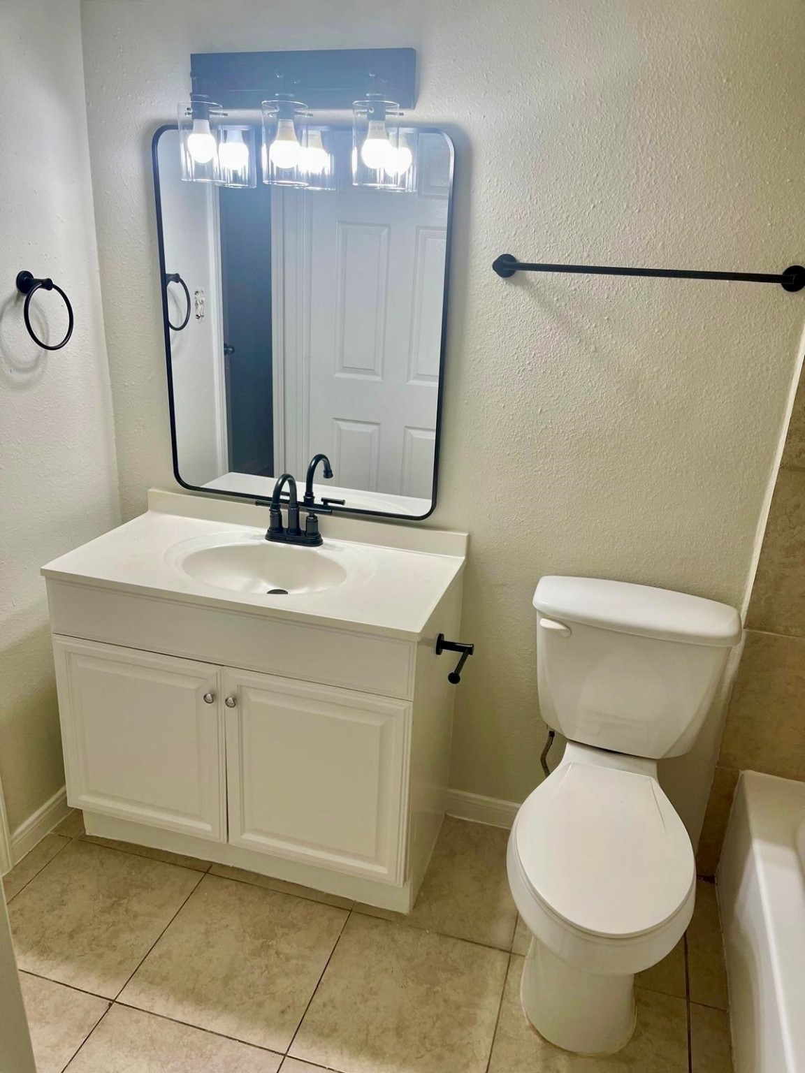 8229 Kingsbrook Road, Unit 228 Houston, TX 77024 - Photo 6 of 17 a bathroom with a sink toilet and mirror