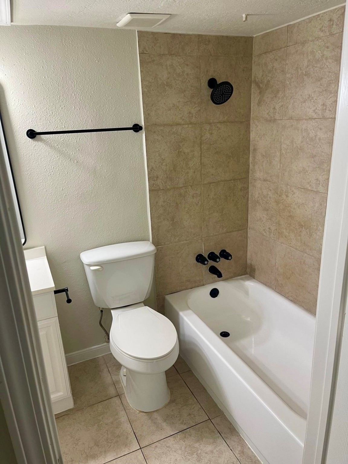 8229 Kingsbrook Road, Unit 228 Houston, TX 77024 - Photo 9 of 17 a white toilet sitting next to a bath tub and a shower