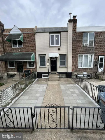 a view of a brick house with many windows