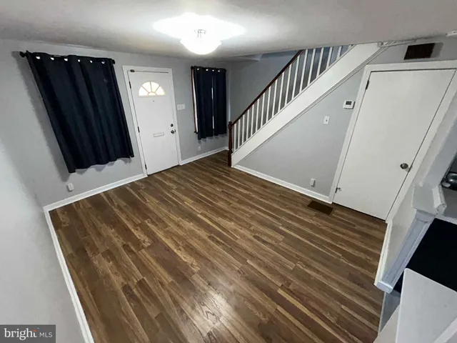 a view of a hallway and wooden floor