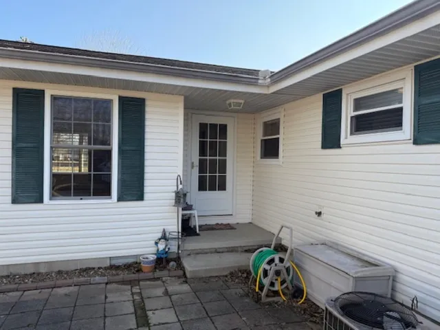 a front view of a house with chairs