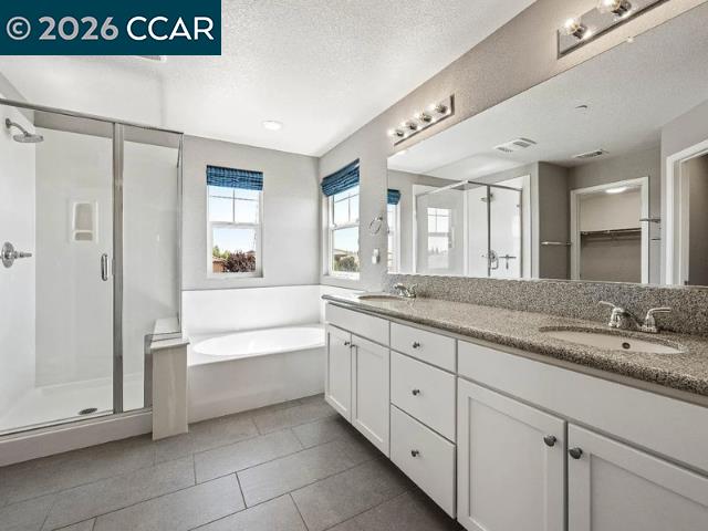 5525 Mossy Stone Way Rancho Cordova, CA 95742 - Photo 18 of 31 a spacious bathroom with a granite countertop sink mirror and bathtub