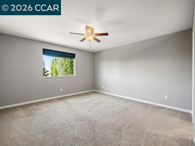 5525 Mossy Stone Way Rancho Cordova, CA 95742 - Photo 26 of 31 an empty room with windows and ceiling fan