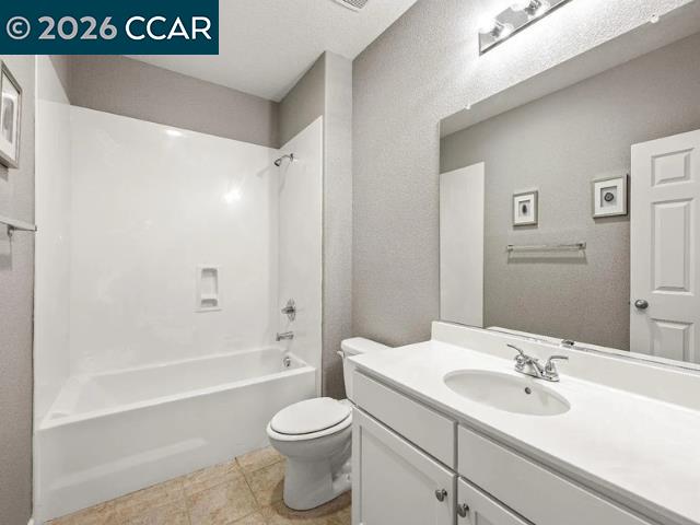 5525 Mossy Stone Way Rancho Cordova, CA 95742 - Photo 29 of 31 a bathroom with a sink a toilet and a large mirror
