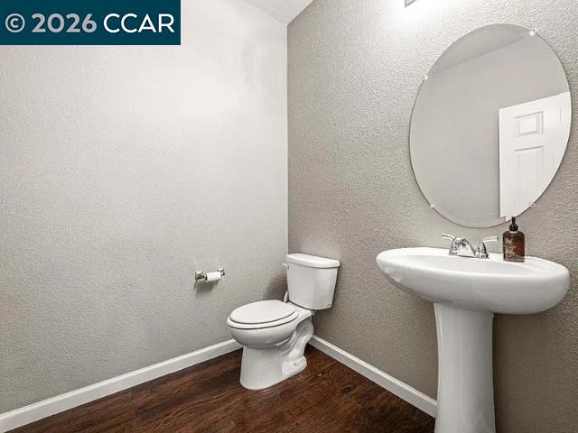 5525 Mossy Stone Way Rancho Cordova, CA 95742 - Photo 30 of 31 a bathroom with a toilet sink and mirror