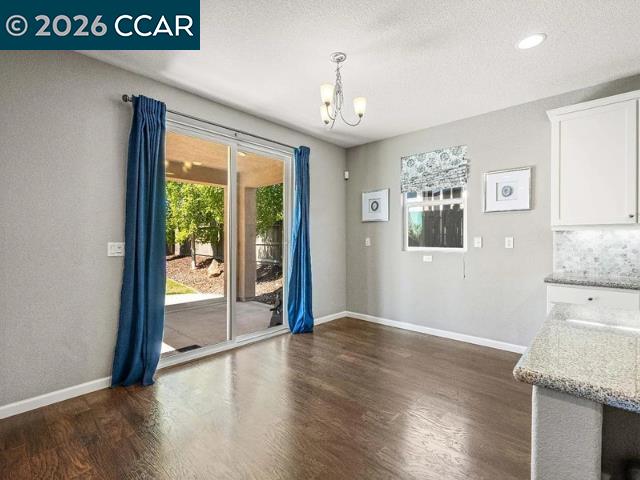 5525 Mossy Stone Way Rancho Cordova, CA 95742 - Photo 8 of 31 a view of an empty room with window and wooden floor