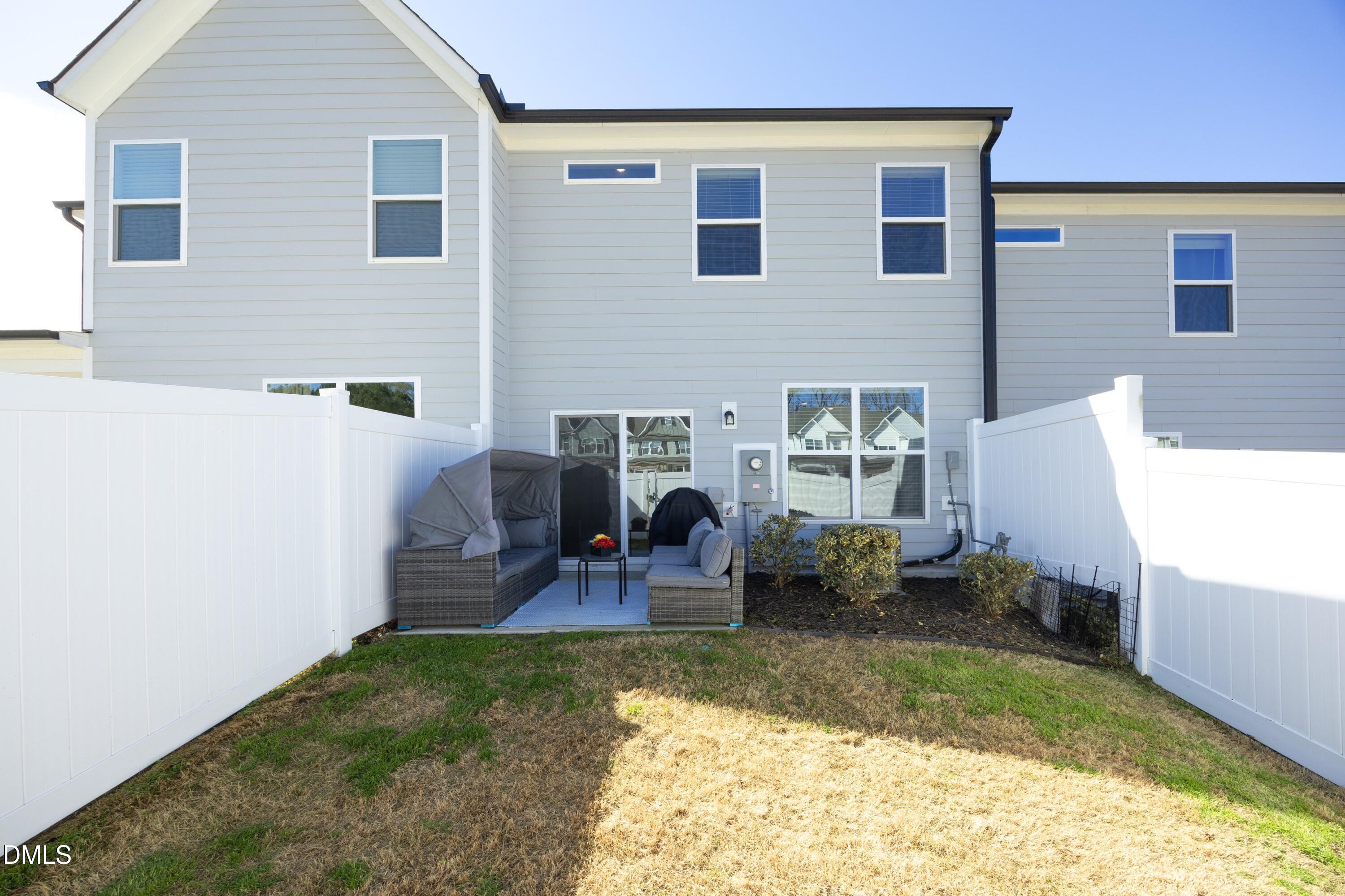 1002 Heartstone Way Durham, NC 27713 - Photo 27 of 35 a view of a house with backyard sitting area and furniture