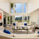a living room with furniture and a floor to ceiling window