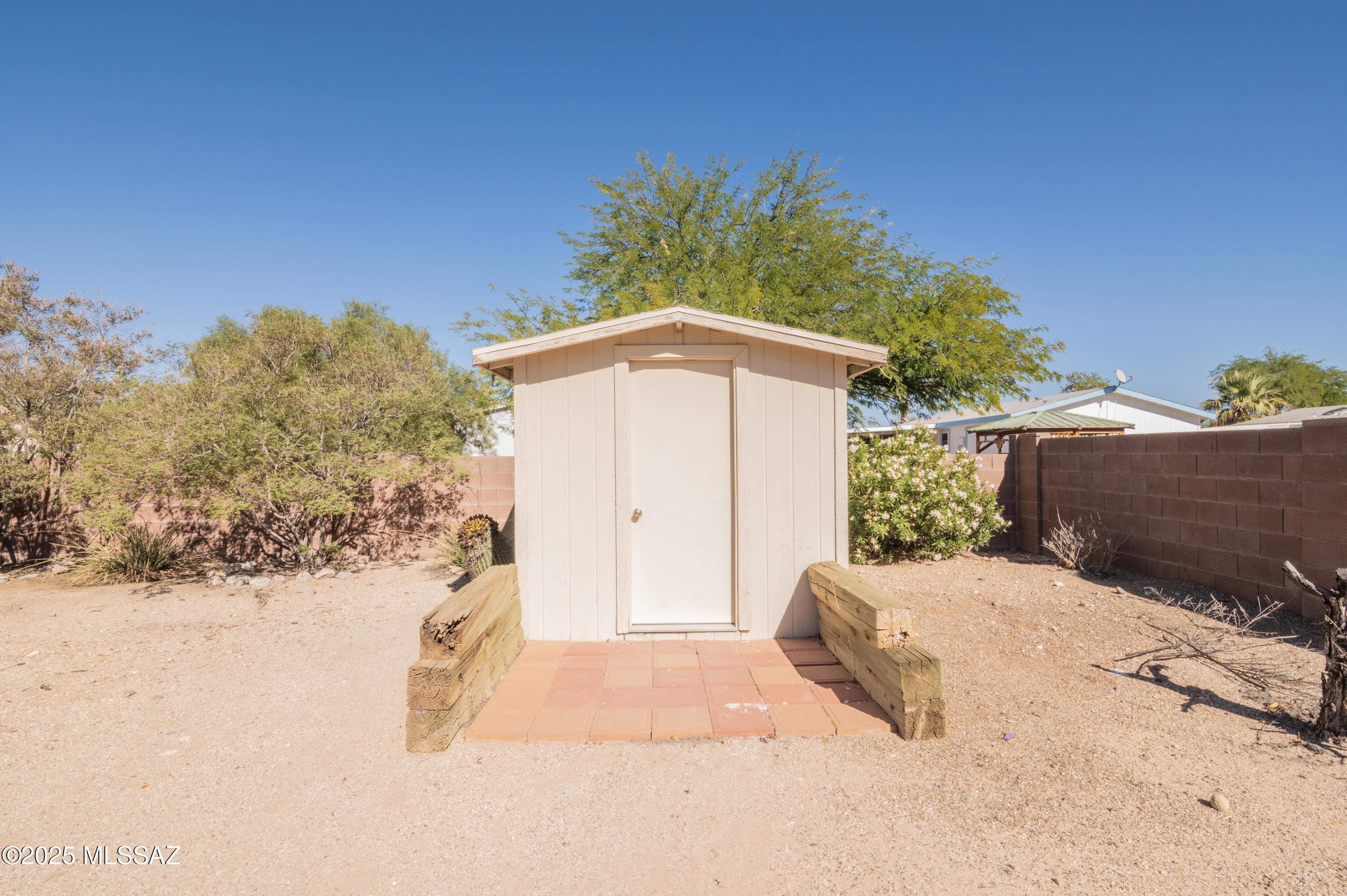 6205 East Rough Rock Drive Tucson, AZ 85756 - Photo 28 of 30 a backyard of a house with wooden fence and trees