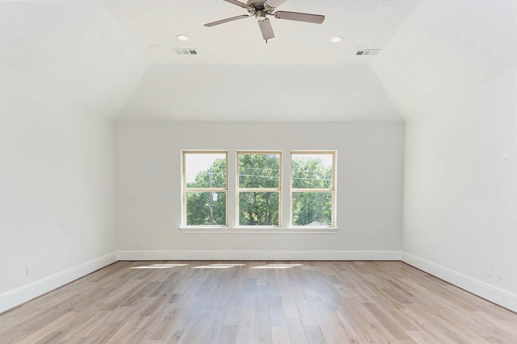 7715 South Fall Run Crossing Houston, TX 77055 - Photo 16 of 22 an empty room with wooden floor fan and windows