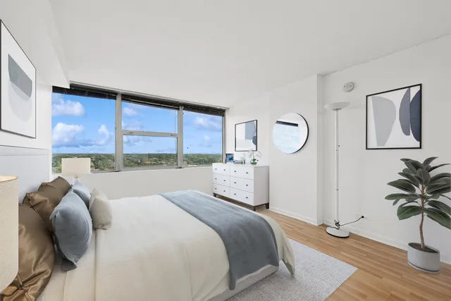 a bedroom with a bed and a potted plant