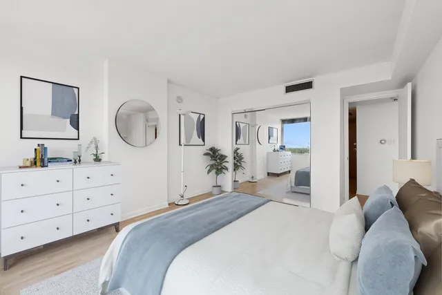 a bedroom with a bed and a dresser