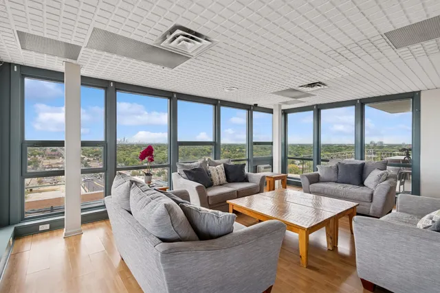 a living room with furniture and a floor to ceiling window