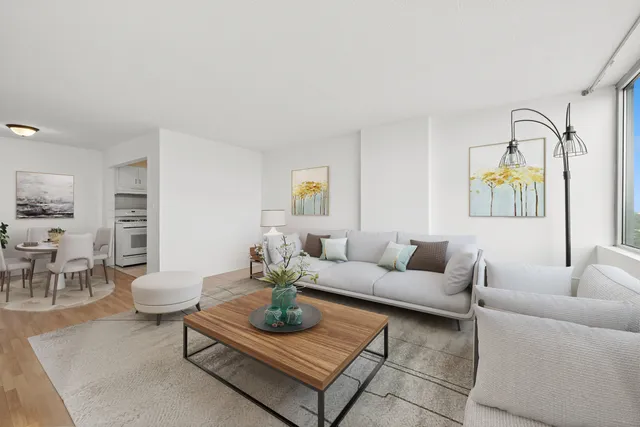a living room with furniture and a dining table with garden view