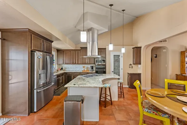 a large kitchen with stainless steel appliances granite countertop a stove a sink dishwasher a microwave oven with cabinets and wooden floor