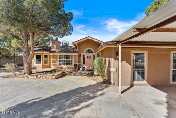 a dining room with furniture a fireplace and chandelier