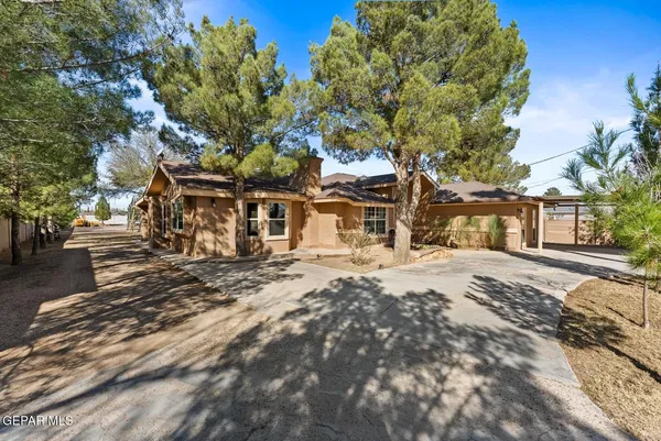 a kitchen with stainless steel appliances kitchen island granite countertop a refrigerator a stove and a sink with wooden floor