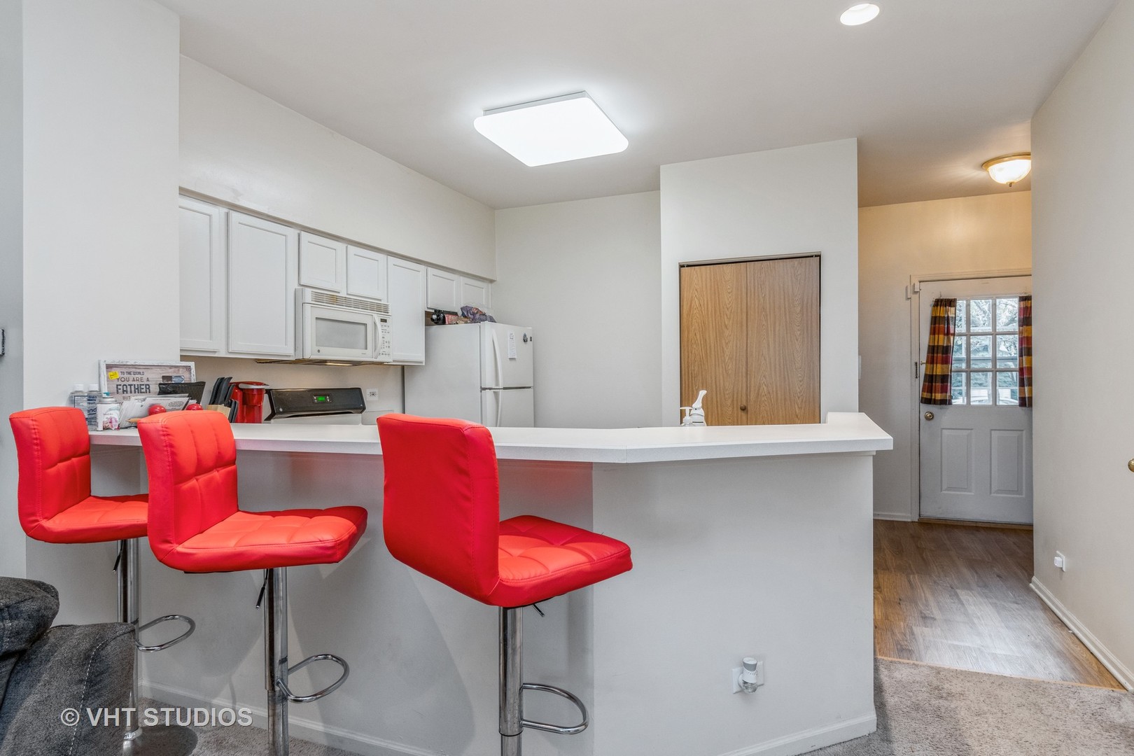 2613 Carrolwood Road Naperville, IL 60540 - Photo 2 of 11 a kitchen with stainless steel appliances kitchen island granite countertop a table chair and white cabinets