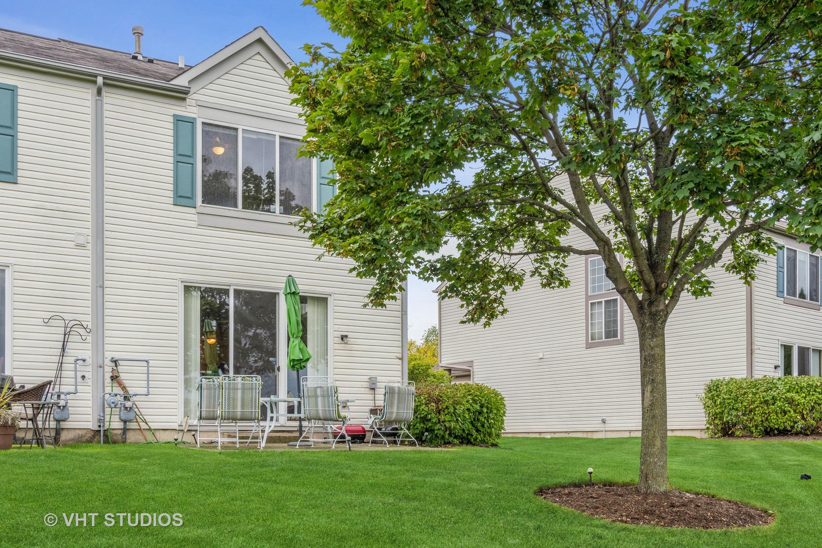 2613 Carrolwood Road Naperville, IL 60540 - Photo 10 of 11 a front view of a house with a garden and plants
