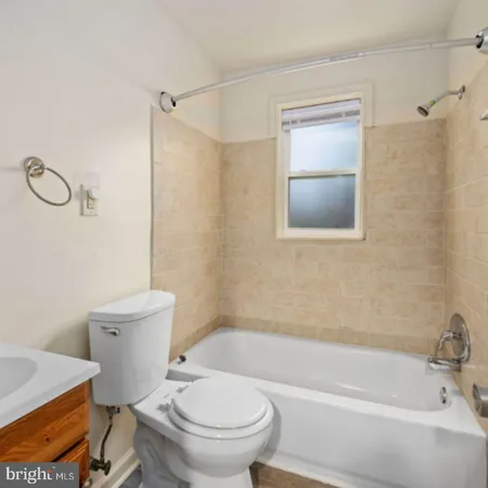 a bathroom with a toilet and a bathtub