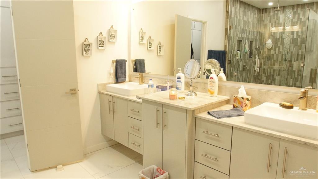 414 Ric Mar Street Edinburg, TX 78541 - Photo 22 of 36 Dual vanity with vessel sinks, beige countertops, and light cabinetry
