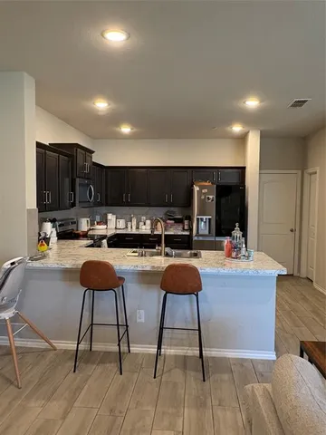 a large kitchen with a table and chairs in it