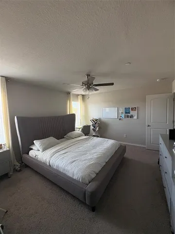 a bedroom with bed and window