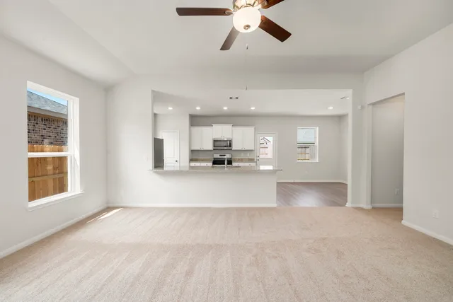 a kitchen with stainless steel appliances granite countertop a sink and dishwasher a stove top oven with wooden floor