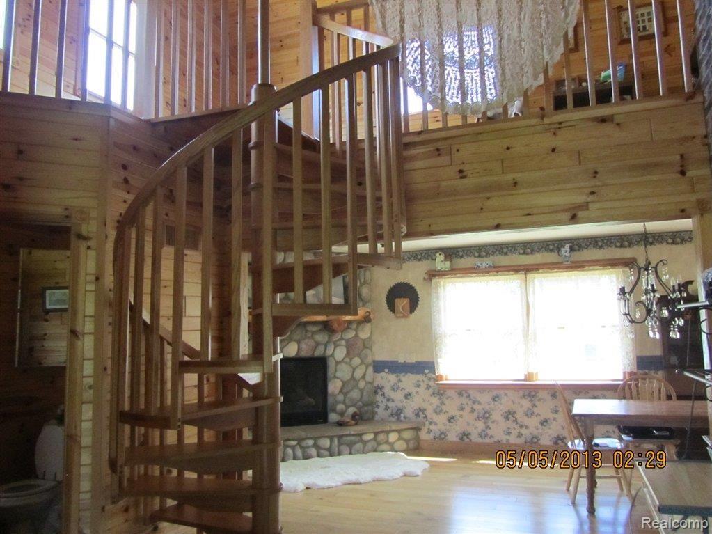 4450 Dutcher Road Howell, MI 48843 - Photo 14 of 25 Spiral stairway from dining room