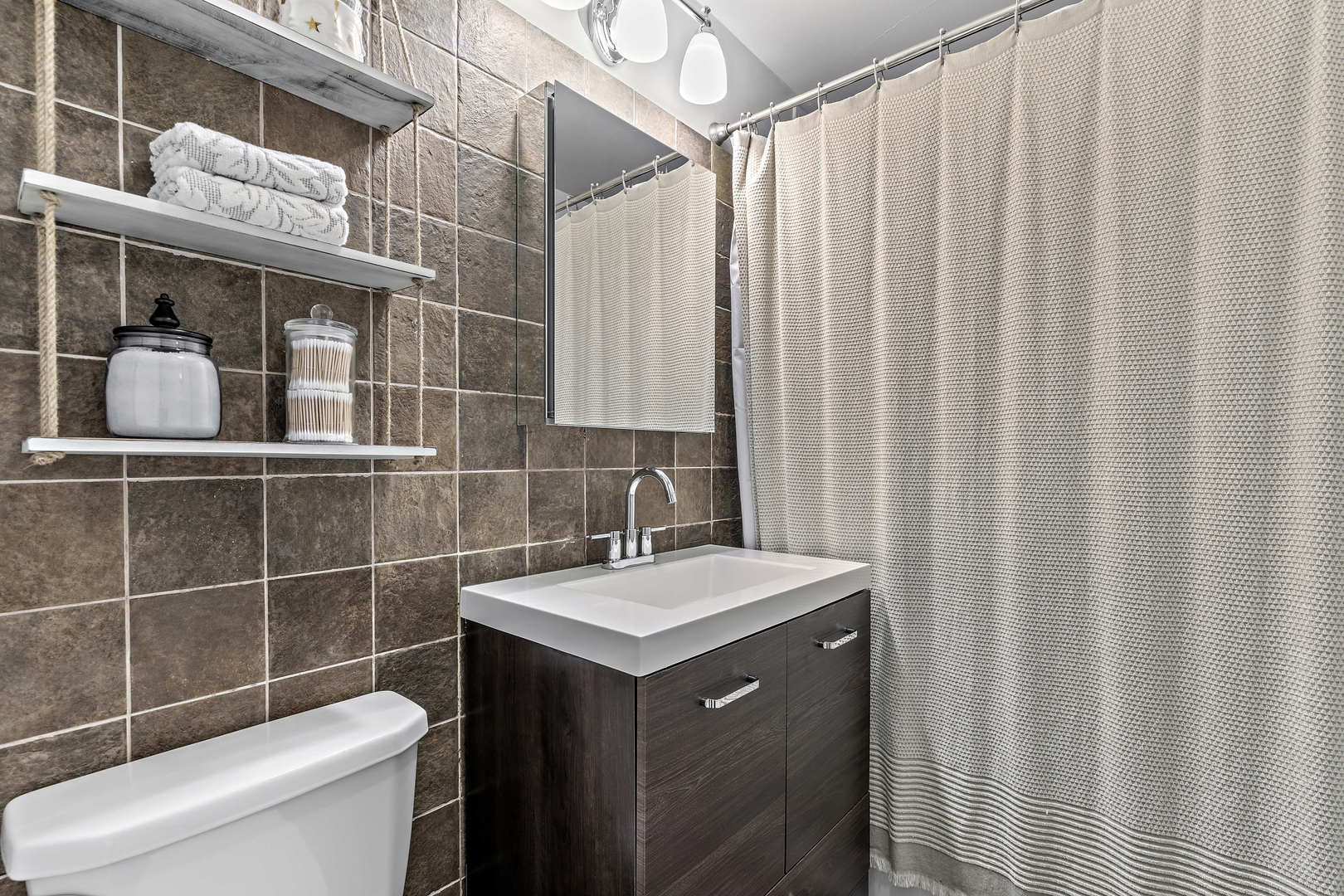 655 West Irving Park Road, Unit 515 Chicago, IL 60613 - Photo 11 of 22 a bathroom with a sink toilet and shower