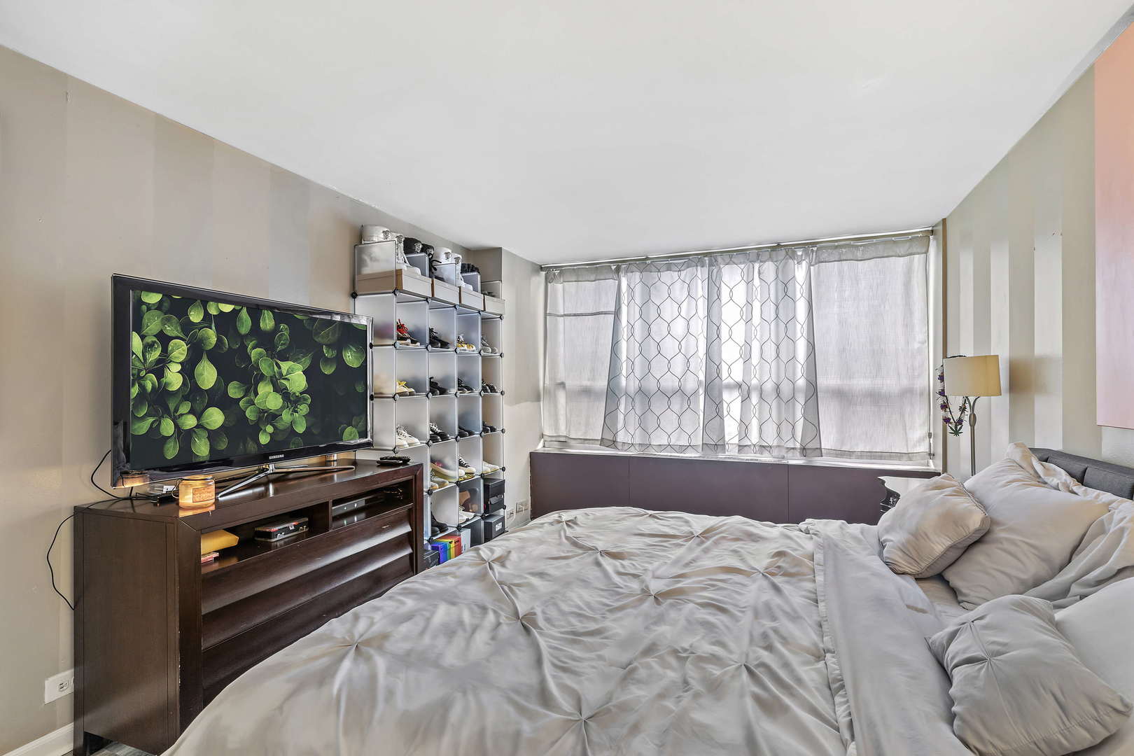 655 West Irving Park Road, Unit 515 Chicago, IL 60613 - Photo 13 of 22 a bedroom with a bed and a flat screen tv