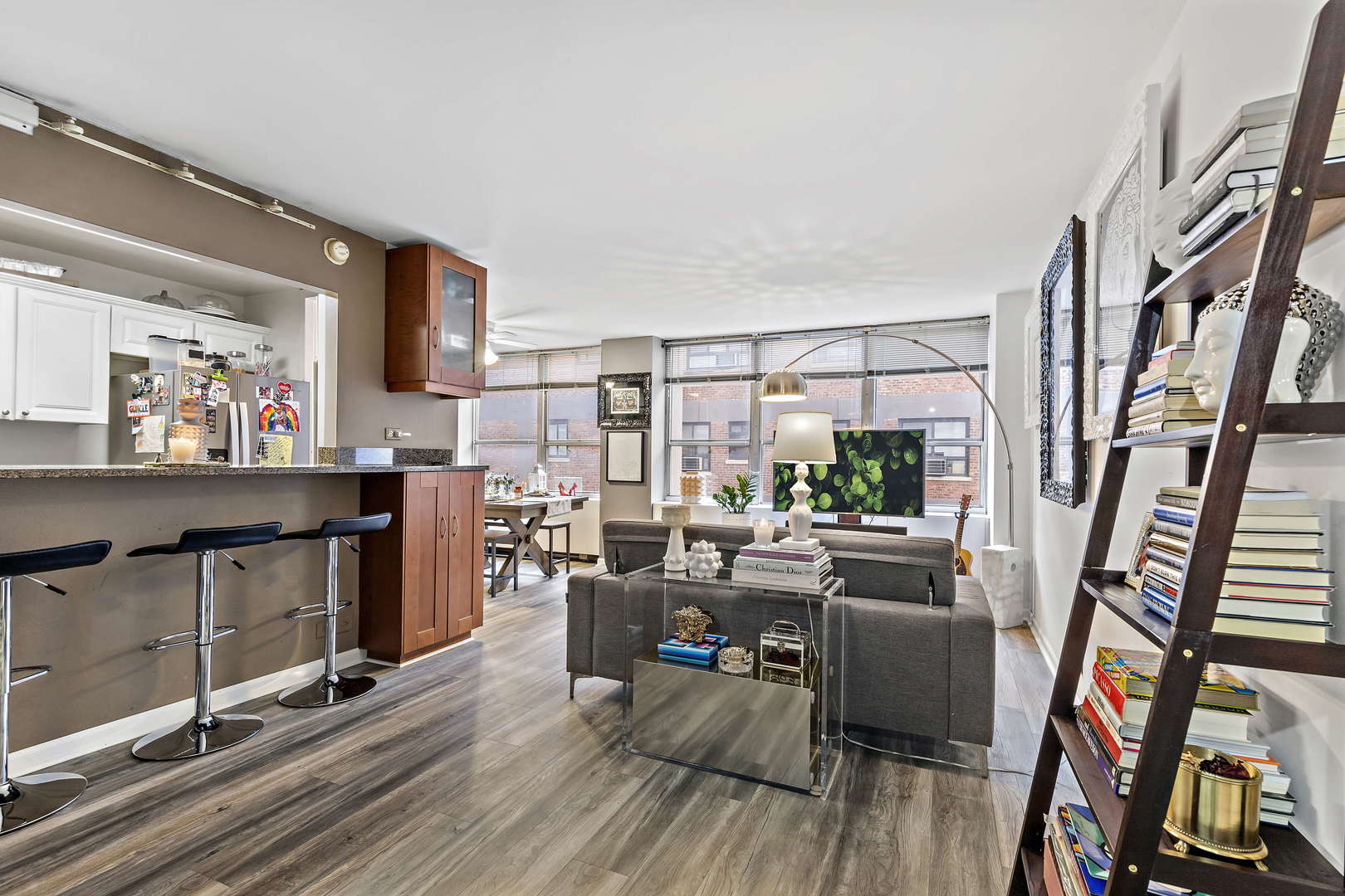 655 West Irving Park Road, Unit 515 Chicago, IL 60613 - Photo 2 of 22 a view of a livingroom with furniture wooden floor and a book shelf