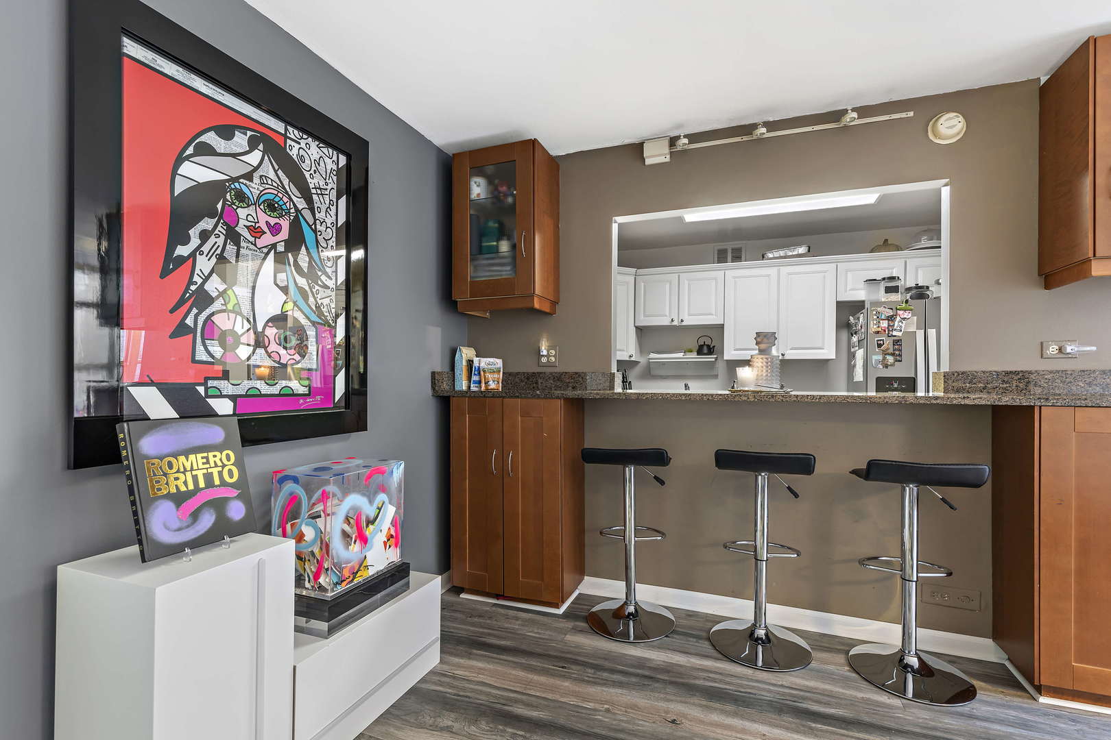 655 West Irving Park Road, Unit 515 Chicago, IL 60613 - Photo 7 of 22 a kitchen with stainless steel appliances granite countertop a sink cabinets and wooden floor